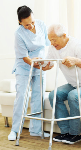 caregiver helping the old man to stand