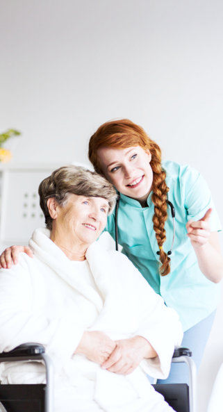 old woman and caregiver looking on outside