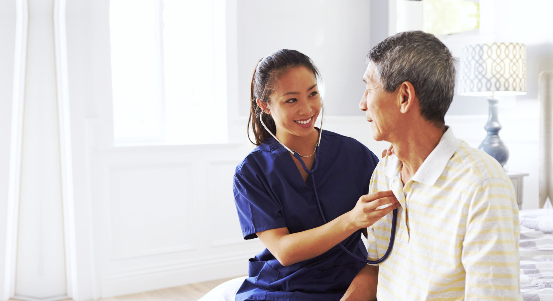 caregiver checking heartbeat of old man